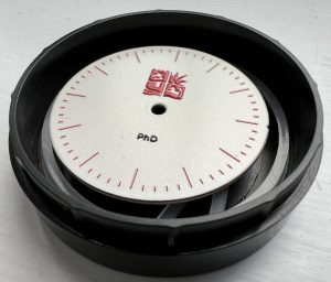 Watch dial in a small round box
