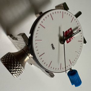 Watch movement with dial and hands on a holder
